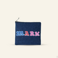 The Goodayy Blue denim pouch with colorful embroidery letters spelling 'MARK' on a beige background