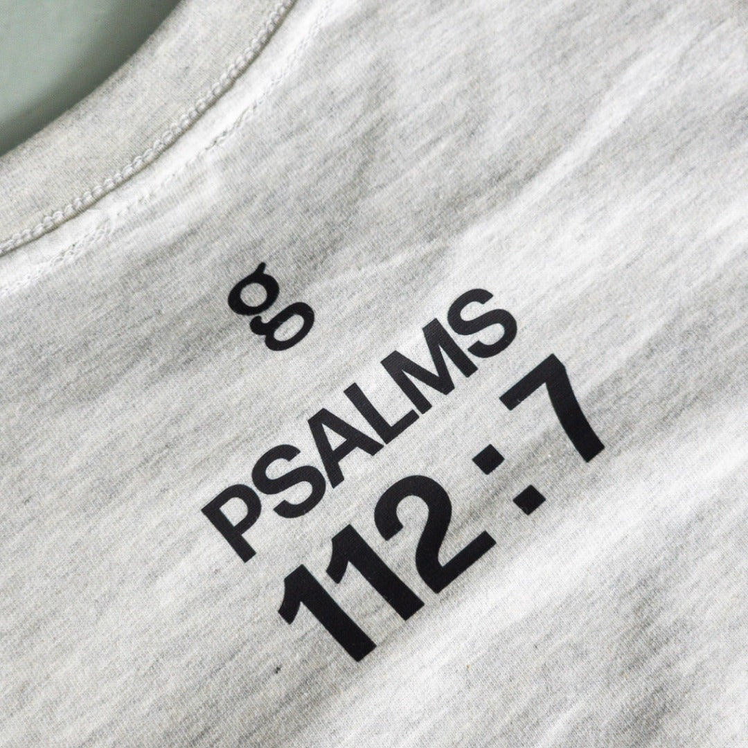 Text 'PSALMS 112:7' printed on a ash grey shirt.