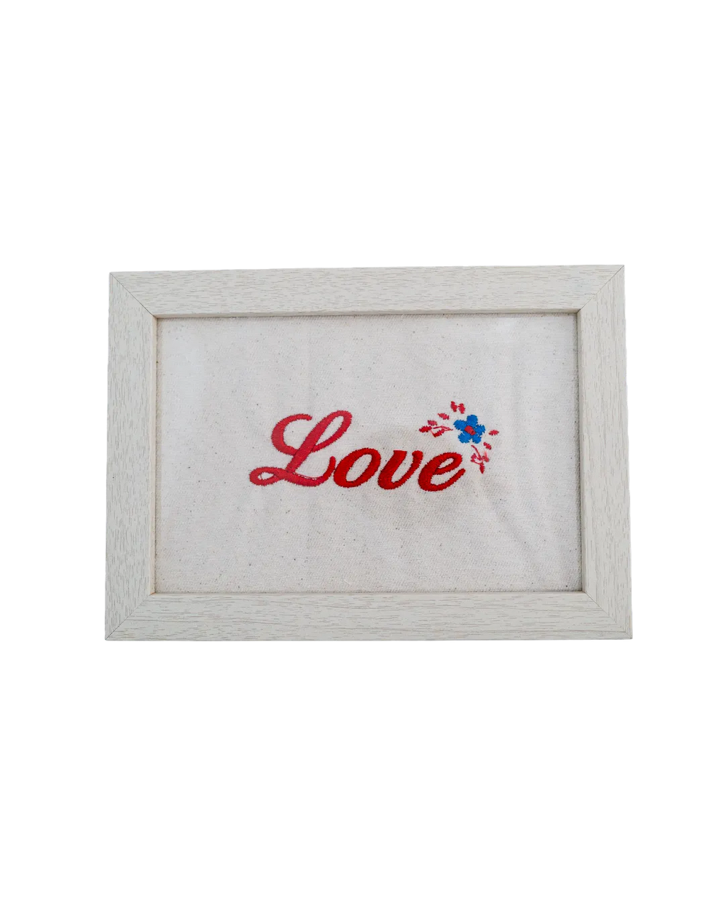 Light wood frame featuring red cursive embroidered text reading "Love" and a small floral detail on cream canvas.