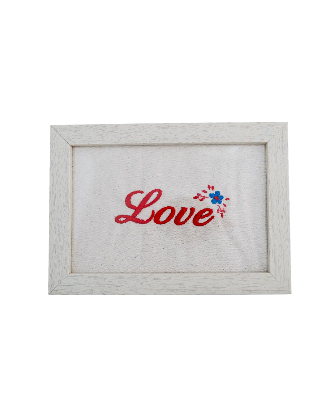 Light wood frame featuring red cursive embroidered text reading "Love" and a small floral detail on cream canvas.