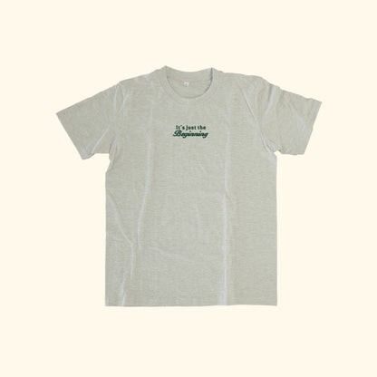Image of model wearing  "its just the beginning" embroidered on a 200gsm cotton tee that is available in 3 colours and available in 4 sizes, S M L XL and 2XL.