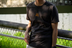 Image of model wearing  "keep going" embroidered on a 200gsm cotton tee that is available in 3 colours and available in 4 sizes, S M L XL and 2XL.