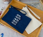 The Goodayy pouches with strap canvas that can personalized with a name or text, one navy and one beige, on a light gray background.