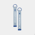 The Goodayy blue keychain strap tag with "crown with goodness, drips with abundance" and "Psalms 65 : 11" printed on the flip side