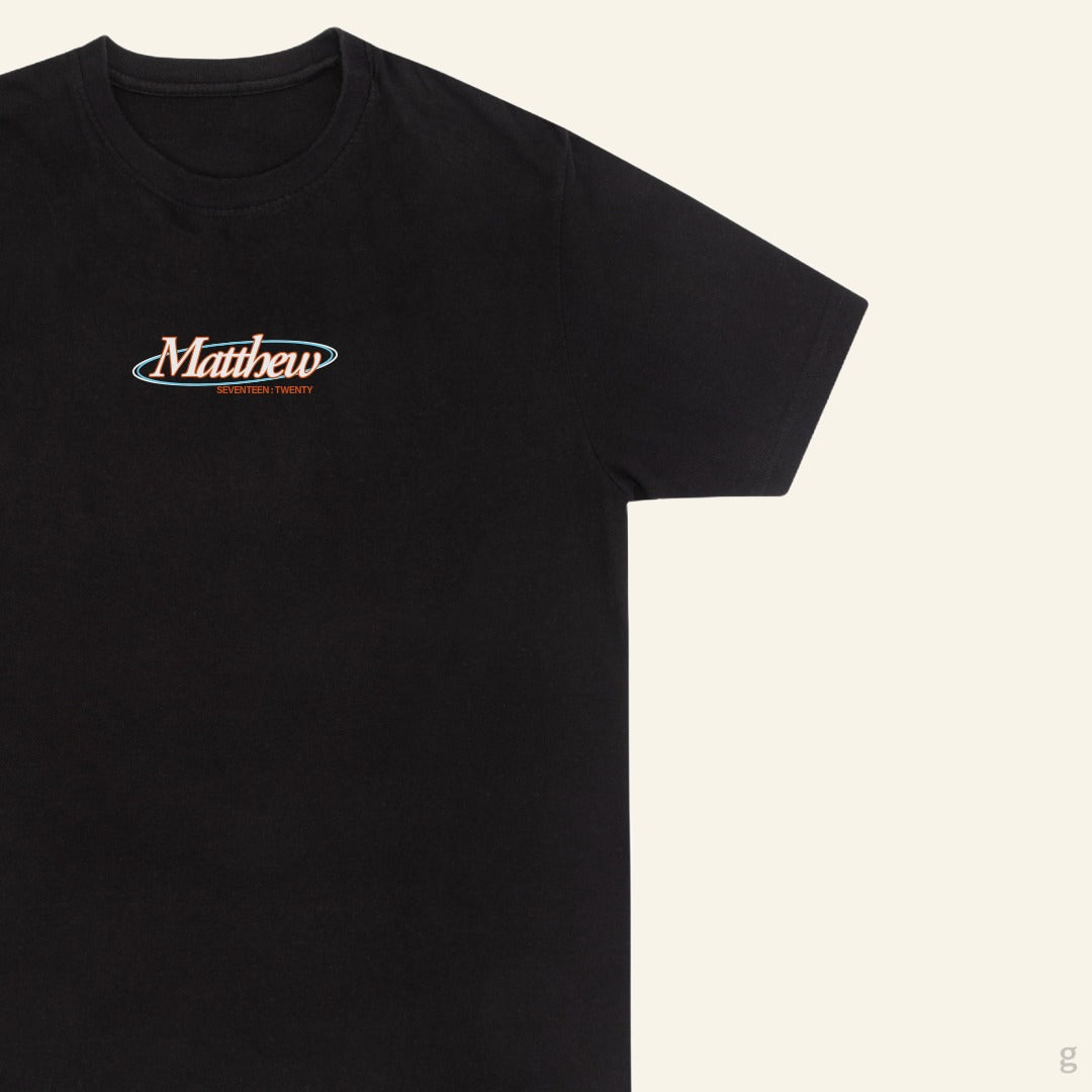 The Goodayy faith can move mountains exclusive faith base black cotton t-shirt close up on the chest print on a white background.